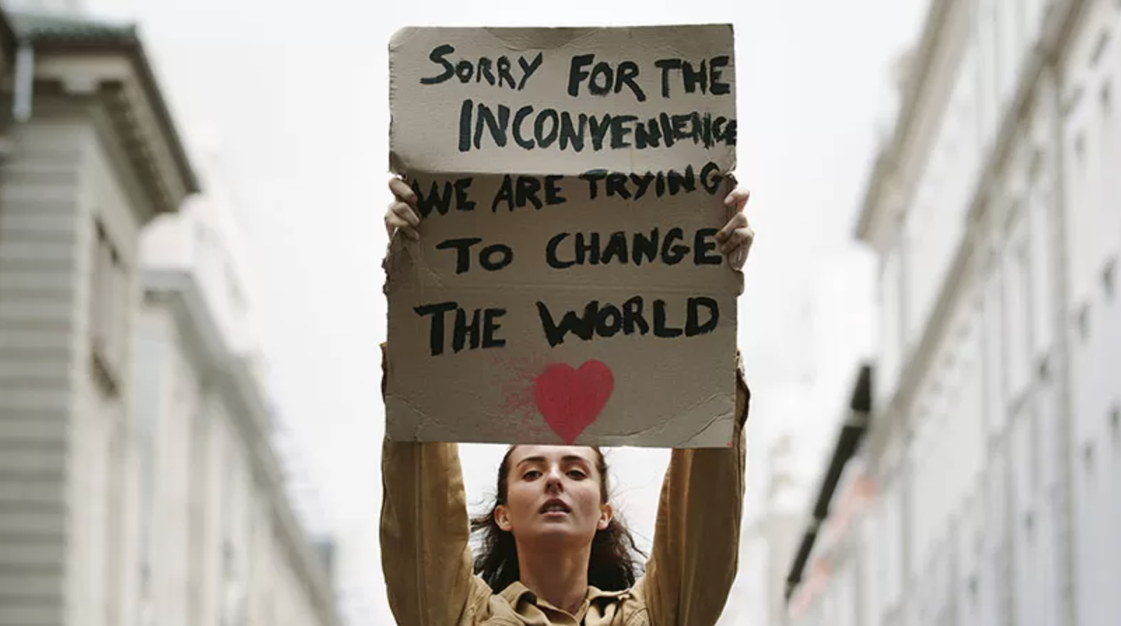 A Gen Zer holds a sign during a protest